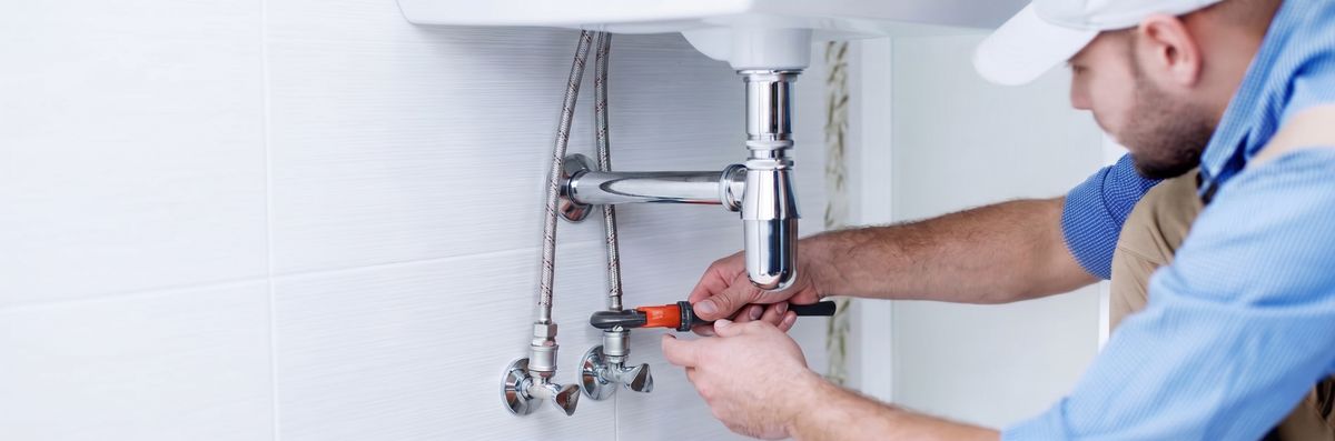 Thomas & Thomas technician performing plumbing and property maintenance work
